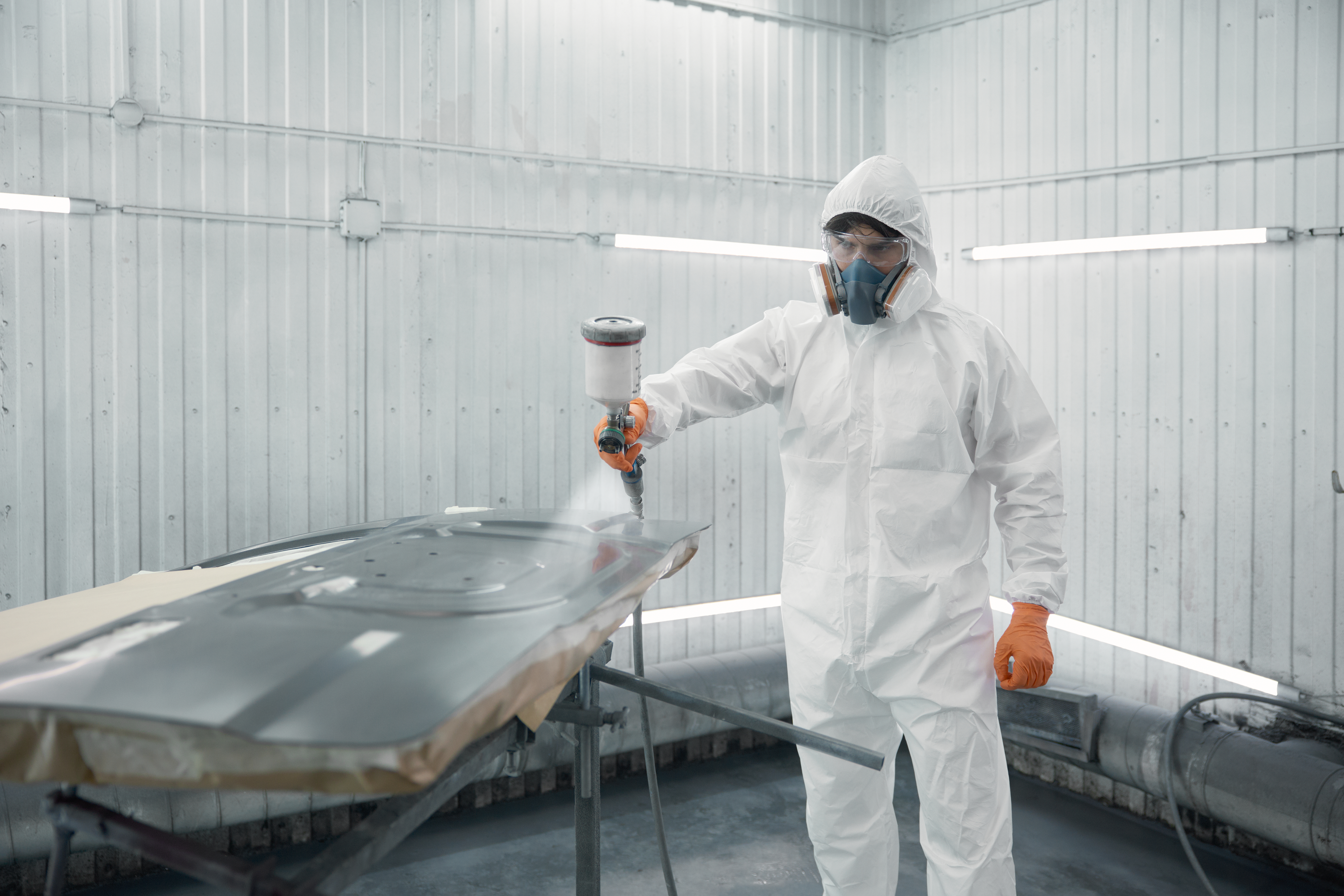 Worker applying protective coating